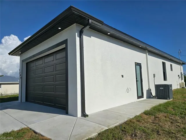 View of property exterior featuring stucco siding and central AC