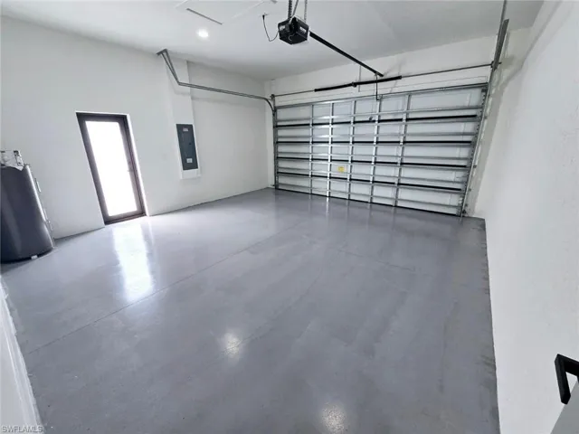 Garage with electric panel and a garage door opener