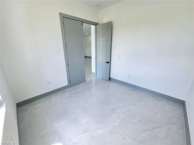 Unfurnished room with baseboards and visible vents
