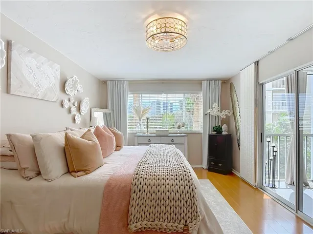Master bedroom with access to outside and light wood finished floors