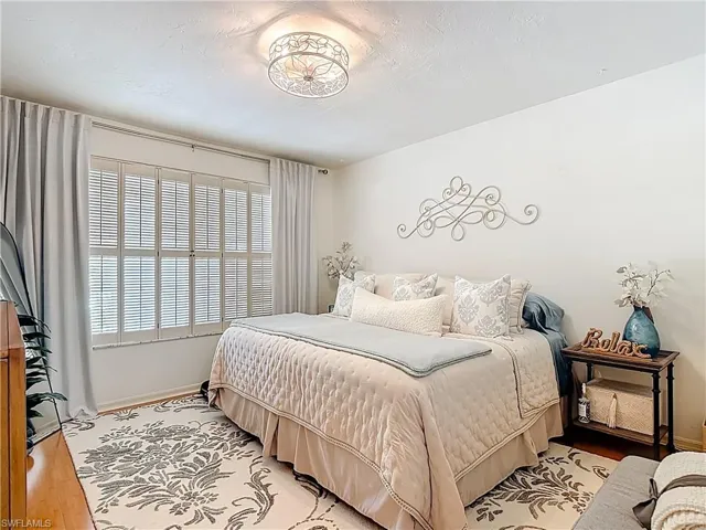 Guest bedroom featuring light wood finished floors and baseboards