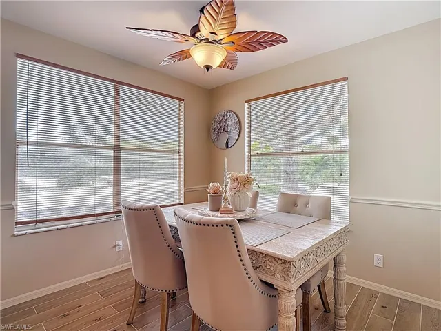 Breakfast room with wood tiled floors, ceiling fan, and plenty of natural light