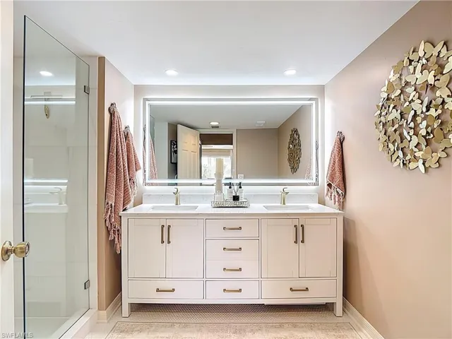Master bathroom with double vanity and a stall shower