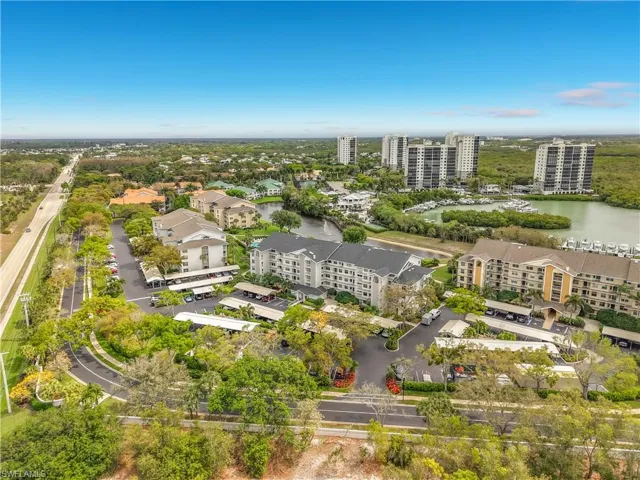 Drone / aerial view of a large body of water and apartment complex