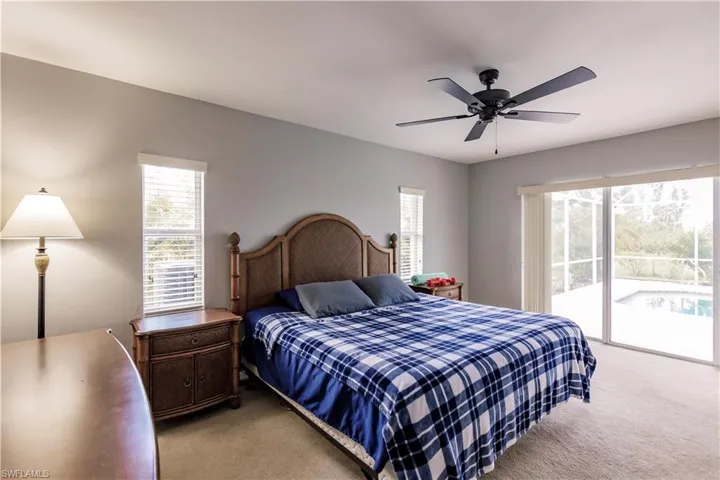 Bedroom featuring access to outside, light carpet, and cei