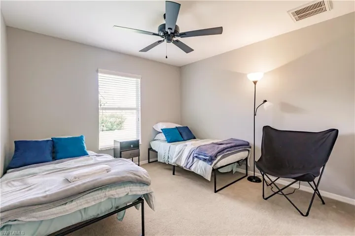 Bedroom with light carpet and ceiling fan