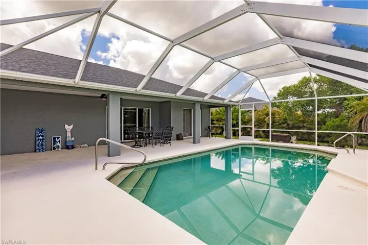View of swimming pool with a patio and a lanai