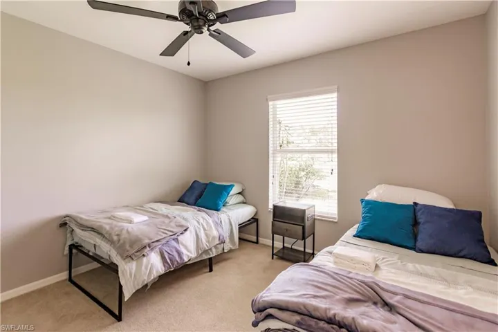 Carpeted bedroom with ceiling fan