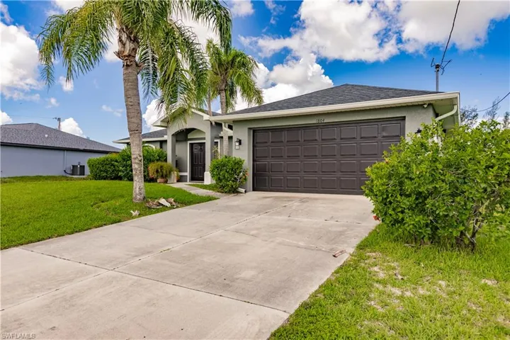 Ranch-style house with a garage, central air condition unit, and a front lawn