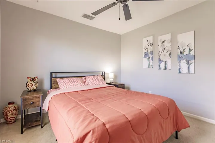 Carpeted bedroom with ceiling fan