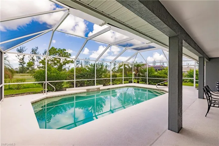 View of swimming pool featuring a patio and a lanai