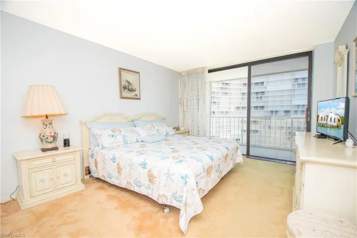 Bedroom featuring light colored carpet, access to outside, and floor to ceiling windows