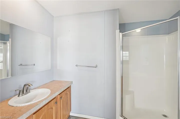 Bathroom with vanity and a stall shower