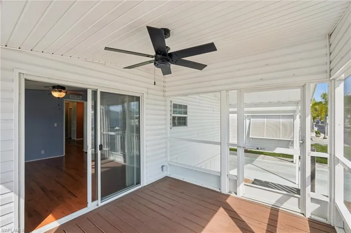Unfurnished sunroom featuring ceiling fan