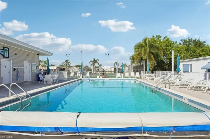 Community pool with a patio