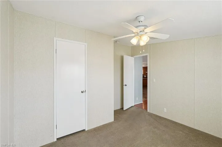 Unfurnished bedroom with carpet and ceiling fan