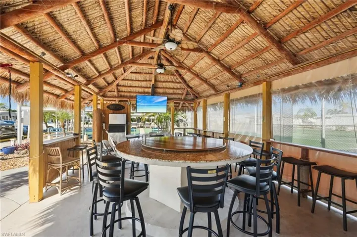 Sunroom featuring finished concrete flooring and a high ceiling