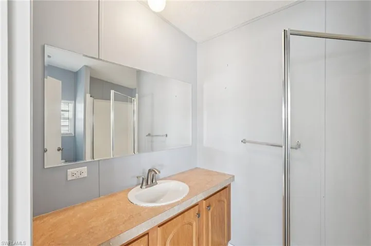 Full bathroom featuring a shower stall and vanity