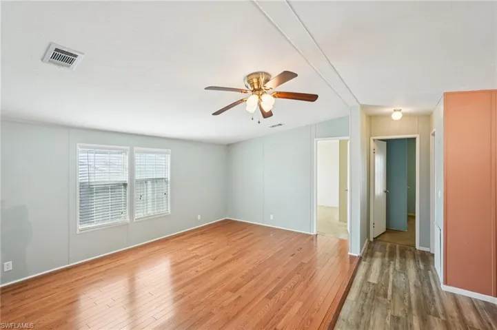Spare room featuring hardwood / wood-style floors and ceiling fan