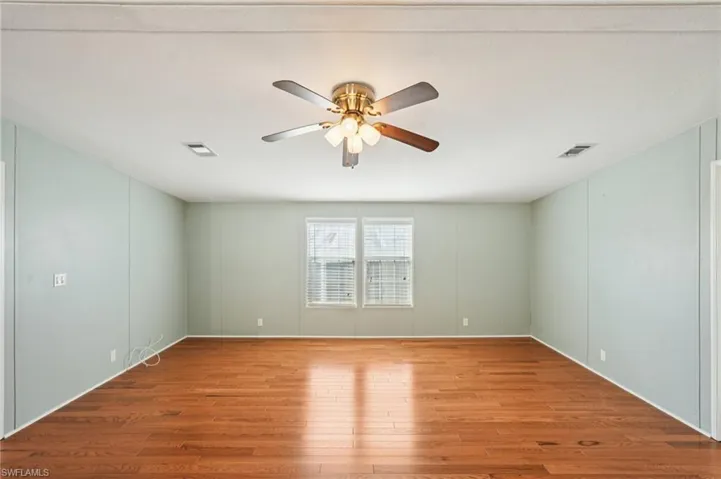 Spare room featuring ceiling fan and wood-type flooring