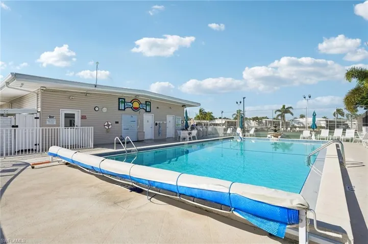 Community pool with a patio