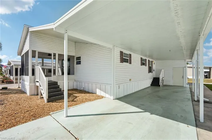 View of home's exterior featuring a carport, a patio area, and concrete driveway