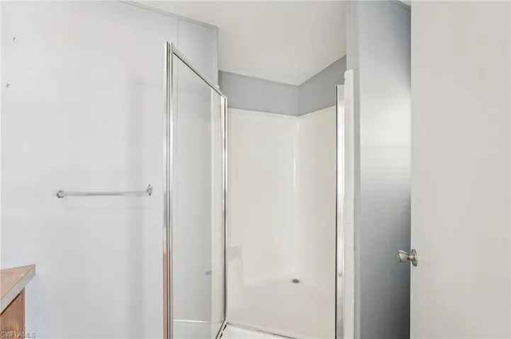Full bath with a stall shower and vanity