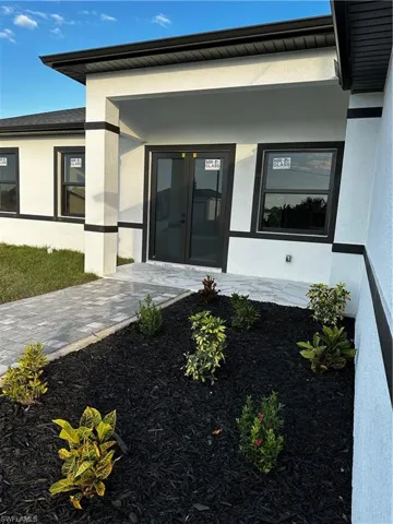 View of exterior entry featuring french doors