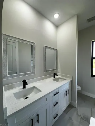 Bathroom featuring vanity and toilet