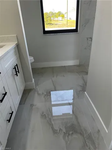 Bathroom featuring vanity and toilet