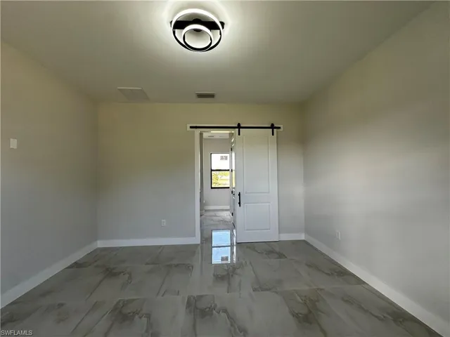 Empty room featuring a barn door