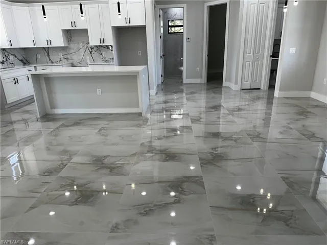 Kitchen featuring white cabinetry and a kitchen island