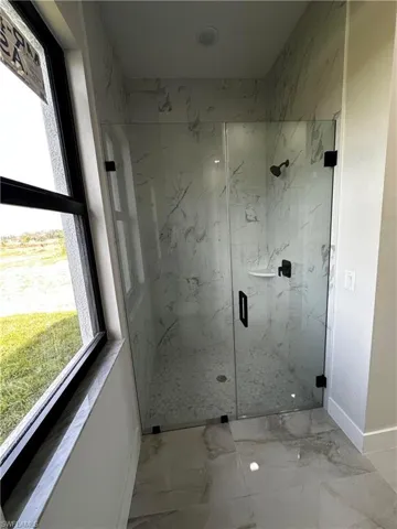 Bathroom featuring a shower with door