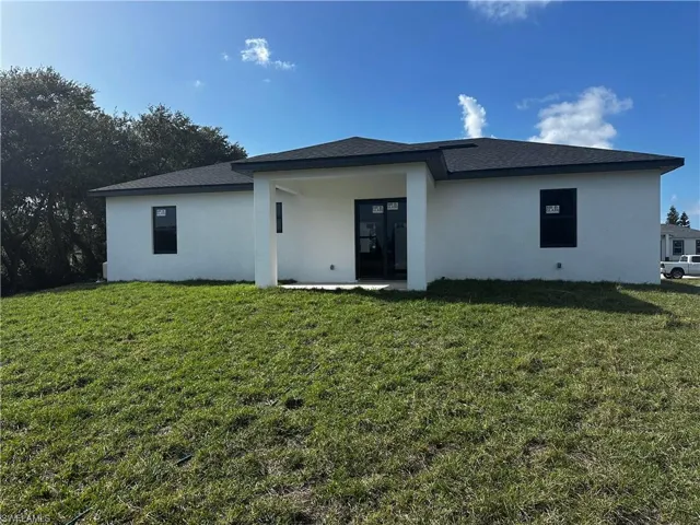 Back of property with a yard