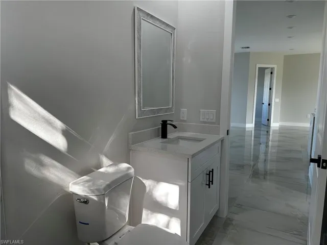 Bathroom featuring vanity and toilet