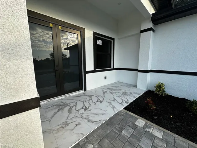 View of exterior entry featuring french doors
