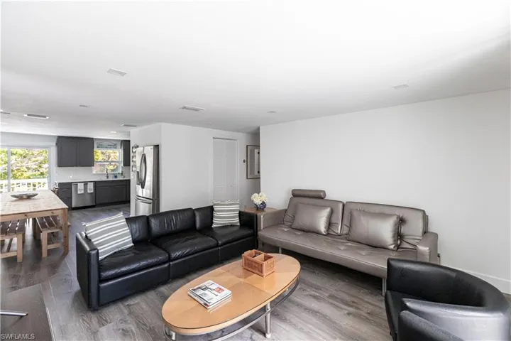 Open-concept living space featuring wood-finish flooring and recessed lighting