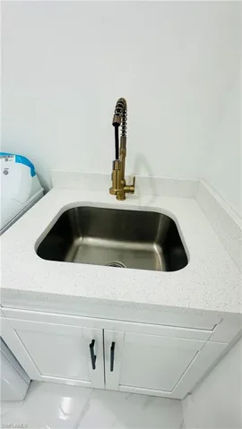 Detailed view of white cabinets and light stone countertops