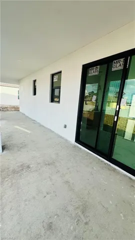 Entrance to property featuring stucco siding