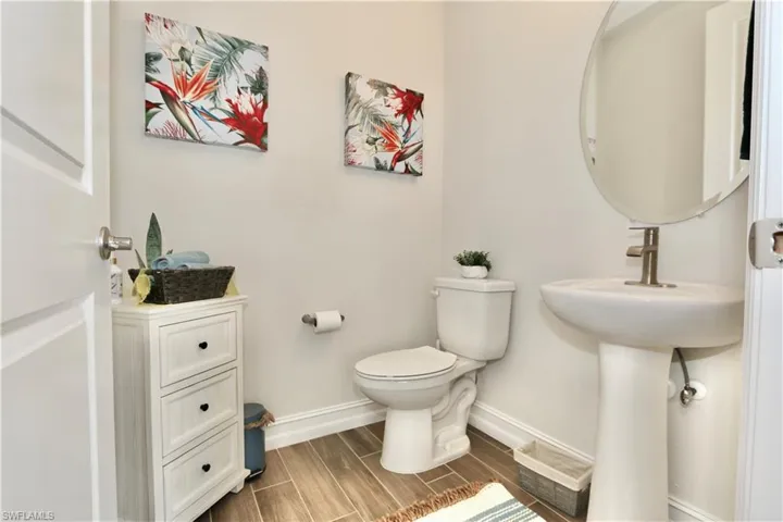 Half bathroom featuring baseboards and wood tiled floors
