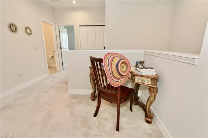 Hall with light carpet and baseboards