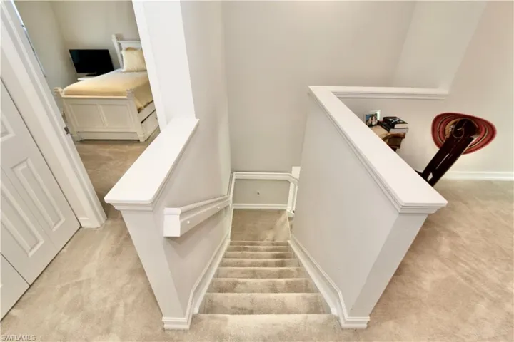 Stairs with carpet flooring and baseboards