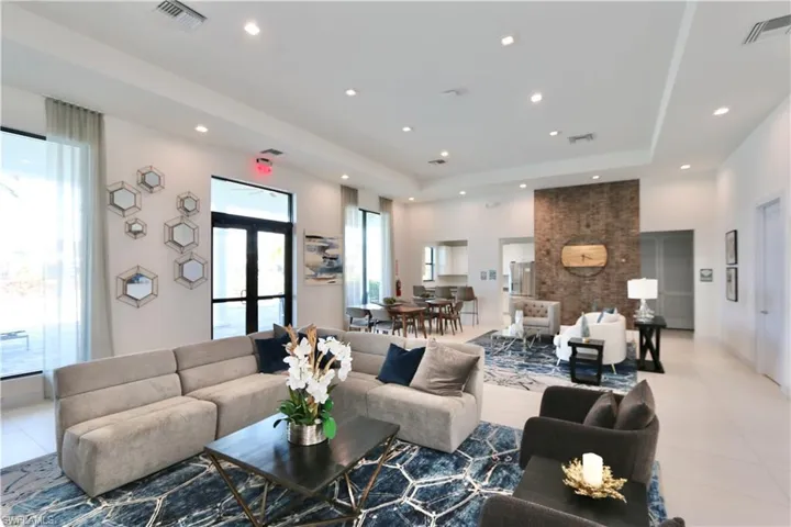 Tiled living area featuring a raised ceiling and recessed lighting