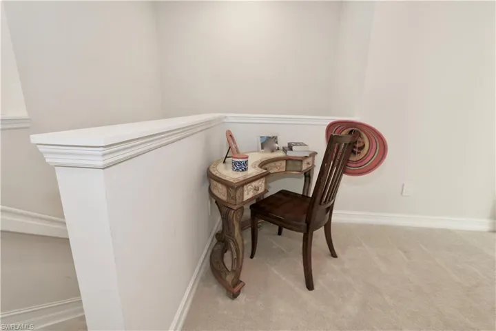 Office with light carpet and baseboards