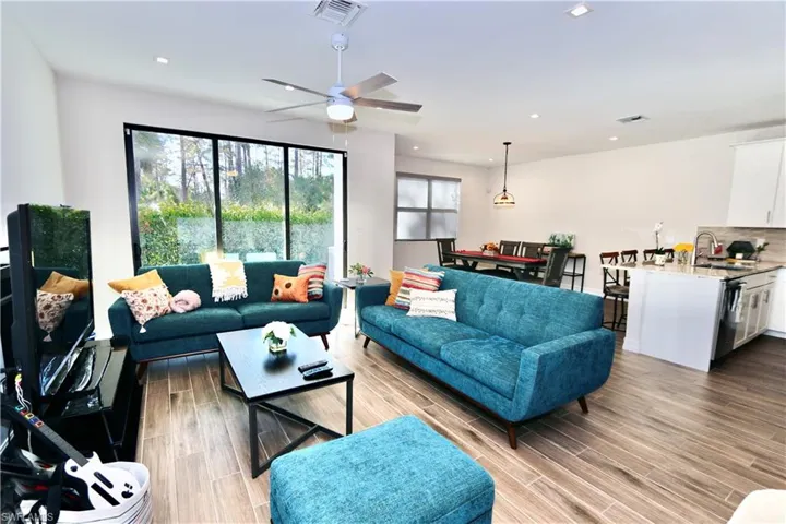 Living area with wood tiled floors, recessed lighting, and ceiling fan