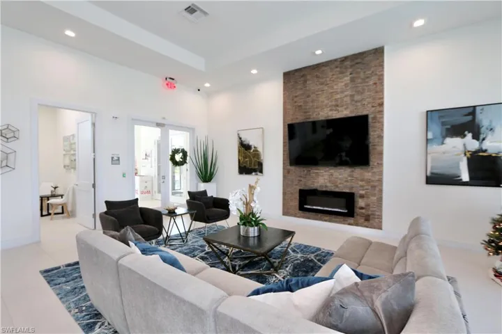 Living room featuring a fireplace, recessed lighting, and light tile patterned flooring