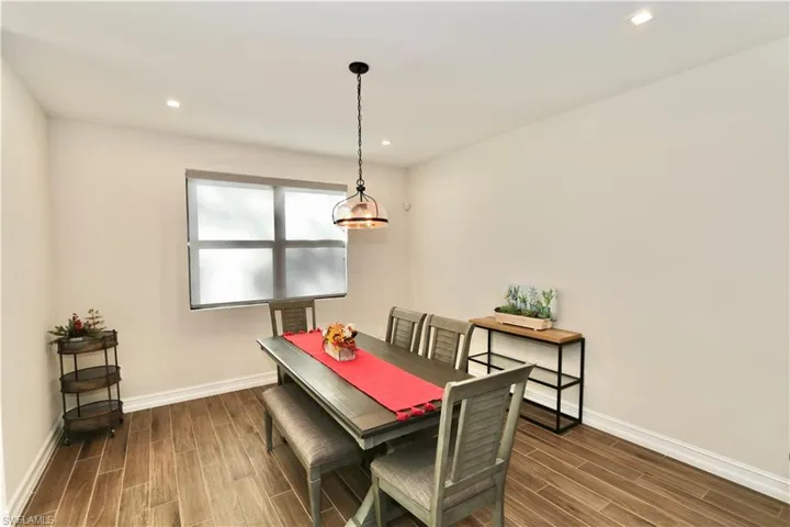 Dining space with wood tiled floors and recessed lighting