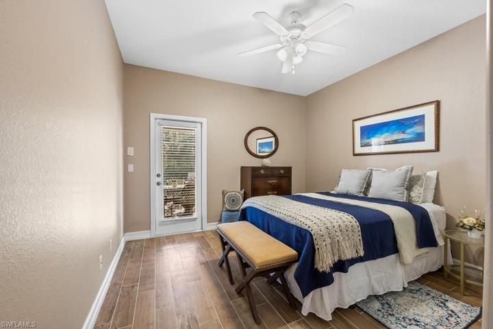 Guest bedroom 2 with pool access and porcelain tile on the floor.