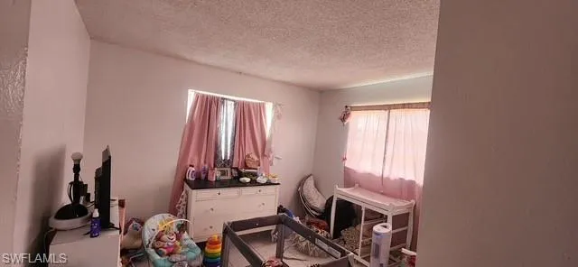 Bedroom featuring a textured ceiling