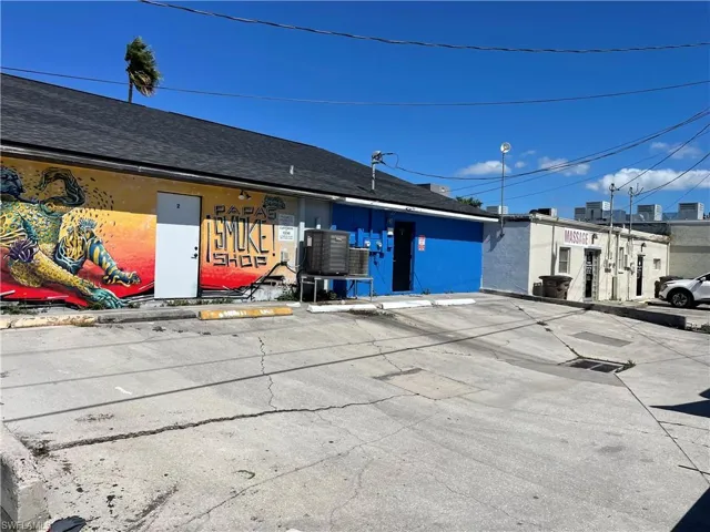 View of building exterior featuring uncovered parking